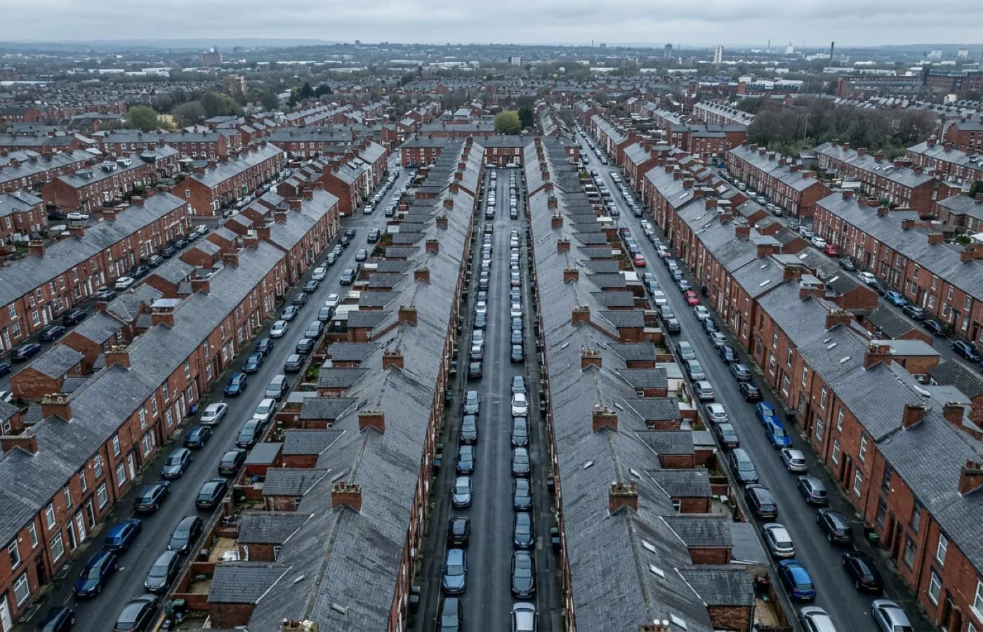 Aerial view over dense urban terracing with parked cars and restricted streets